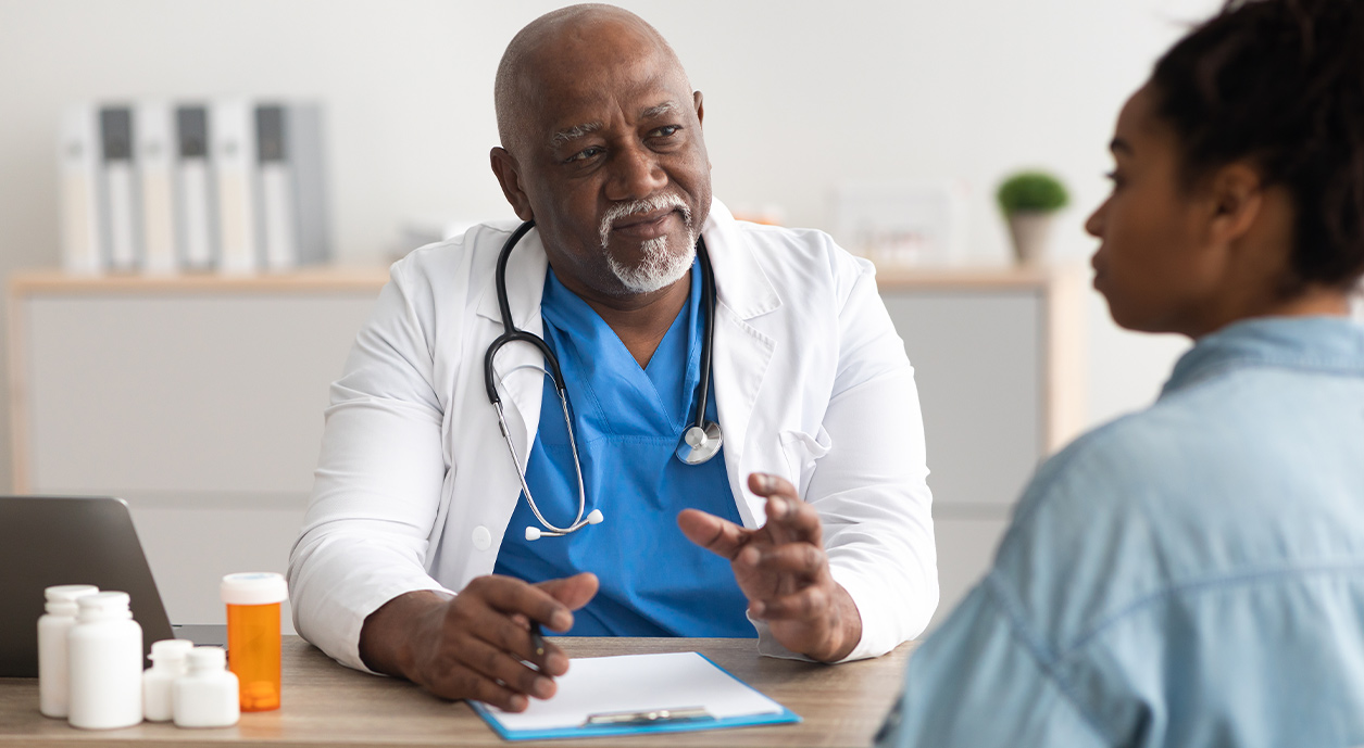 doctor talking about cancer screening with female patient