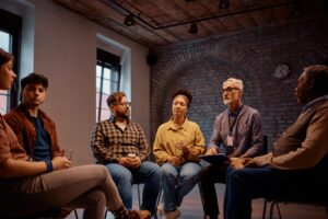 Diverse group of people seeking mental health therapy in Polk County, talking in a group
