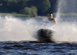 Man on watercraft at lake during a Florida summer day