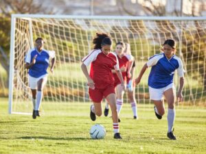 Kids playing a soccer match outdoors, illustrating how to get kids moving through fun physical activities