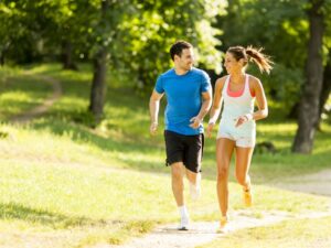 Couple exercising outdoors to promote healthy habits during National Diabetes Awareness Month.